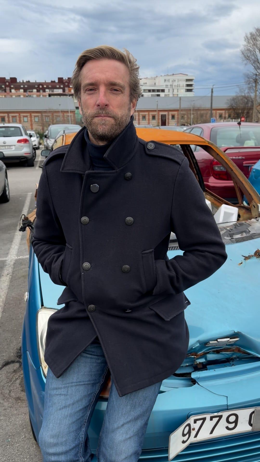 Felipe Piña junto al coche calcinado en Varadero